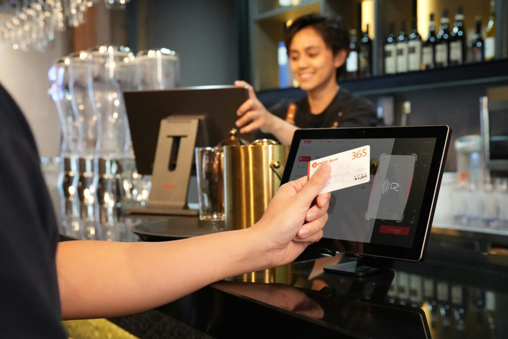 Student paying with a travel-friendly credit card at an overseas café.