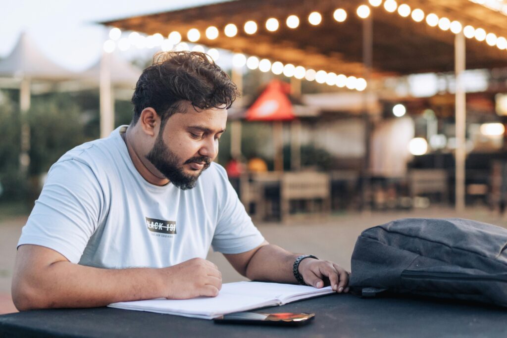 Young student paying with credit card at an international café.